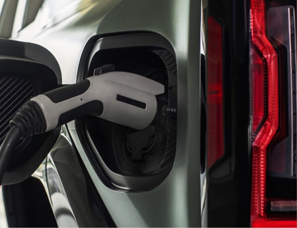 Close up of charging port with charger plugged in on a GMC Hummer EV SUV - Grubbs GMC of Wichita Falls in WICHITA FALLS TX